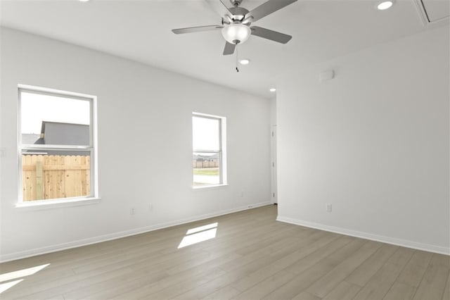 332 Witchhazel Way, San Marcos, TX 78666 - empty room with light wood-style floors, recessed lighting, ceiling fan, baseboards, and attic access
