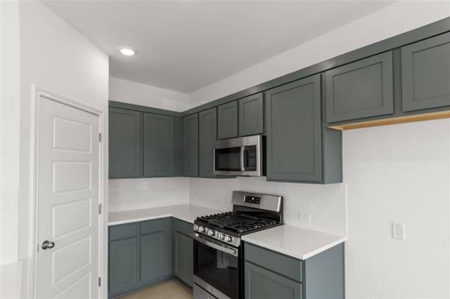 332 Witchhazel Way, San Marcos, TX 78666 - kitchen with appliances with stainless steel finishes, decorative backsplash, and light countertops
