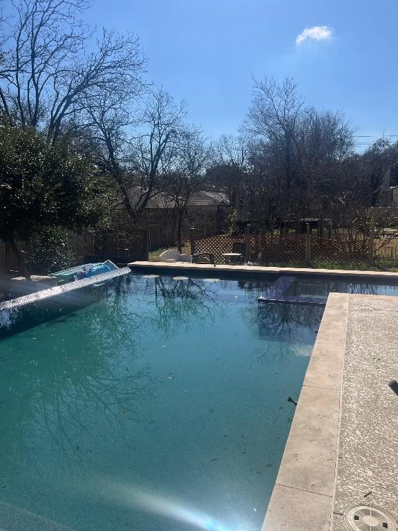 view of swimming pool with a fenced backyard and a fenced in pool