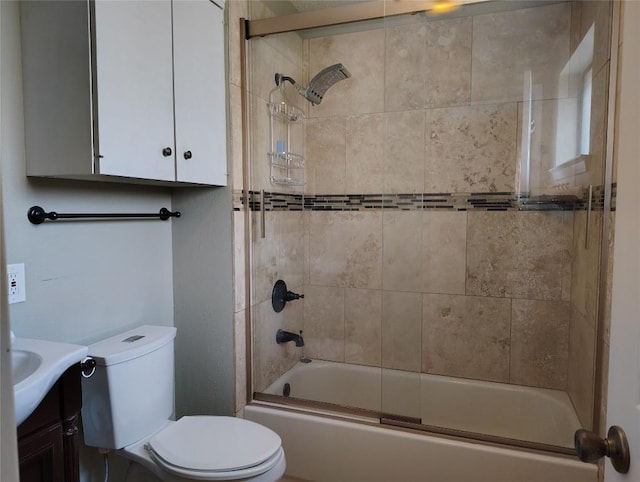 full bathroom with toilet, bath / shower combo with glass door, and vanity