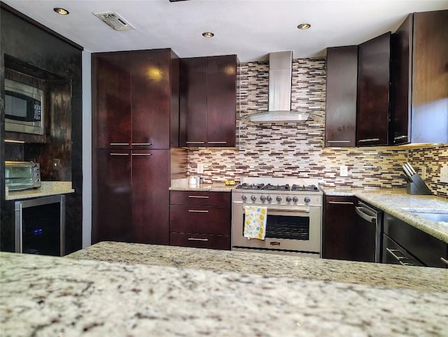 kitchen with tasteful backsplash, visible vents, wall chimney exhaust hood, appliances with stainless steel finishes, and light stone counters