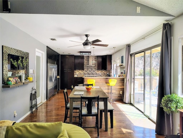 dining area with visible vents, ceiling fan, baseboards, and wood finished floors