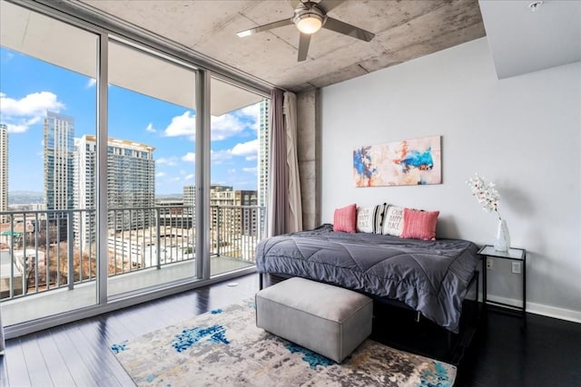 bedroom with floor to ceiling windows, wood-type flooring, access to exterior, and ceiling fan