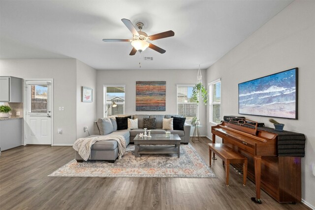 living room featuring hardwood / wood-style flooring and ceiling fan