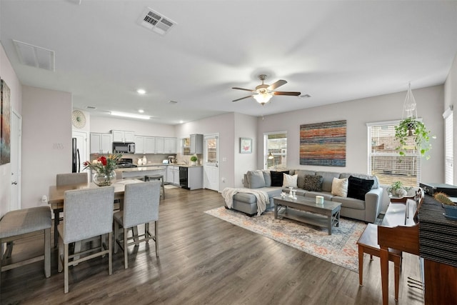 living room with ceiling fan, dark wood-type flooring, visible vents, and recessed lighting