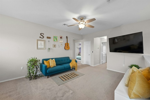 carpeted living room with visible vents, ceiling fan, and baseboards