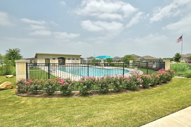 community pool featuring a yard and fence