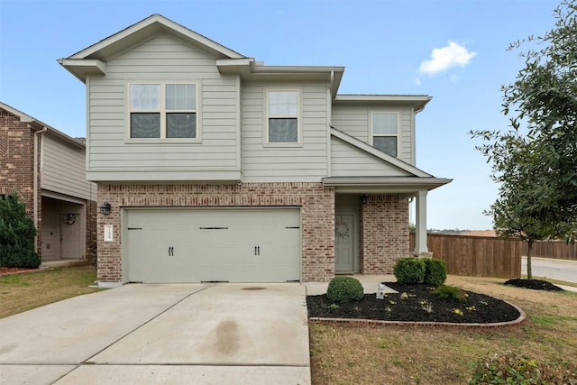 view of front of house featuring a garage, driveway, brick siding, and fence