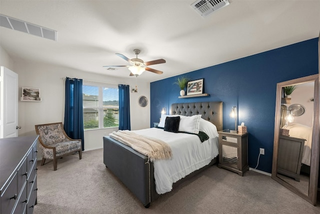 carpeted bedroom featuring baseboards, visible vents, and a ceiling fan