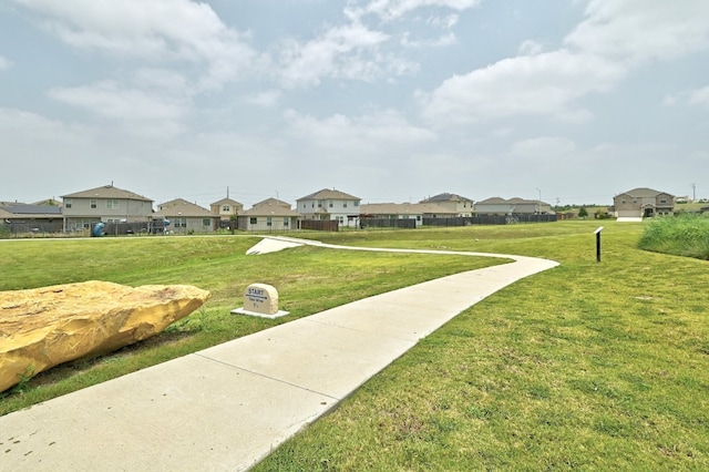 view of home's community with a residential view and a lawn