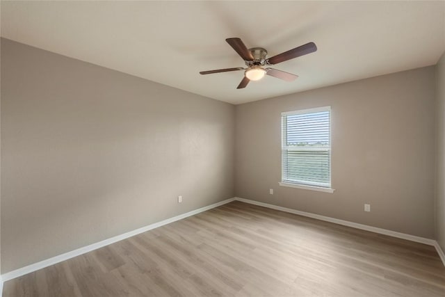 spare room with light hardwood / wood-style flooring and ceiling fan