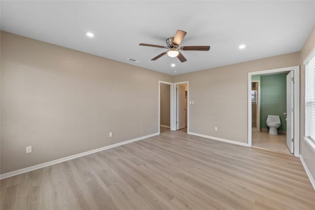 unfurnished bedroom with ceiling fan, ensuite bath, and light hardwood / wood-style flooring