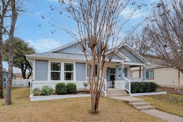 bungalow-style home with a front yard