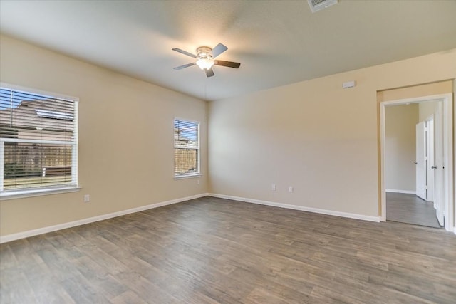 spare room featuring wood-type flooring and ceiling fan