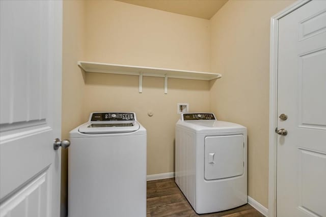 clothes washing area featuring washer and dryer and dark hardwood / wood-style floors