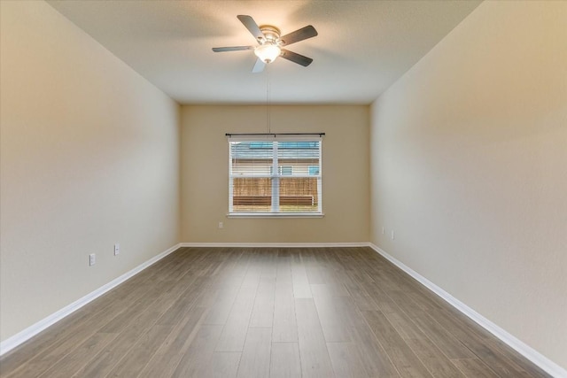 spare room featuring ceiling fan and hardwood / wood-style floors