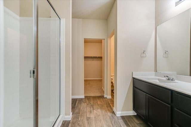 bathroom featuring vanity, hardwood / wood-style floors, and walk in shower