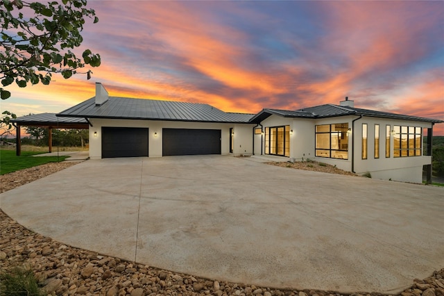 view of front of property with a garage and a carport