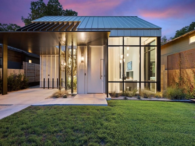 exterior space with a carport and a yard