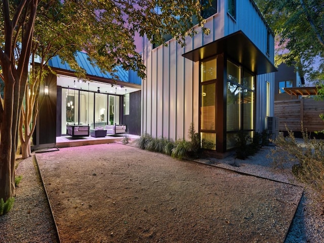 back of house with an outdoor hangout area and a patio