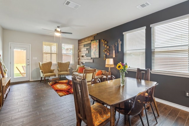 dining space featuring wood tiled floor, visible vents, ceiling fan, and baseboards