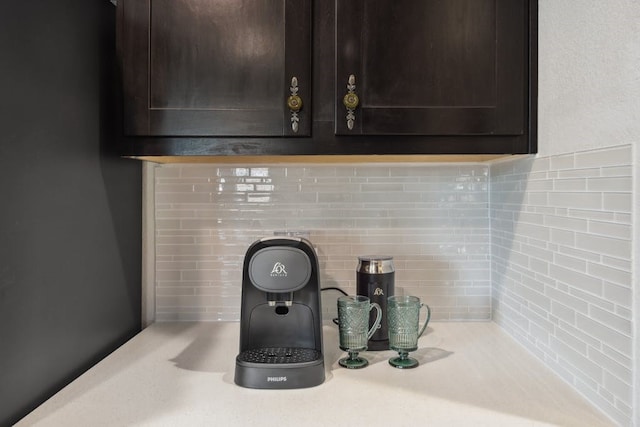 interior details with light countertops and dark brown cabinetry