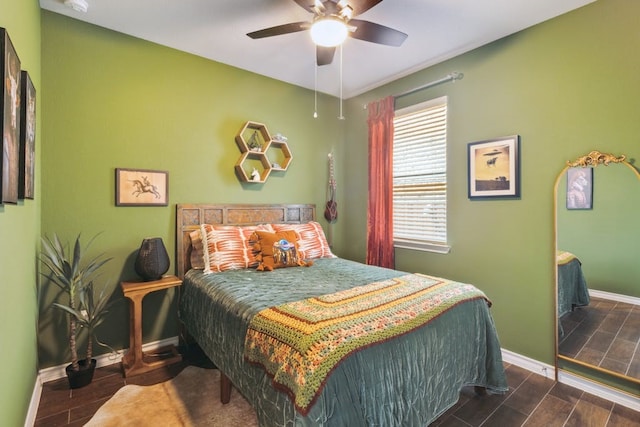 bedroom featuring wood tiled floor, baseboards, and ceiling fan