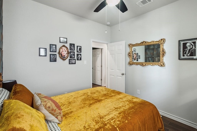 bedroom featuring a ceiling fan, baseboards, visible vents, and wood finished floors