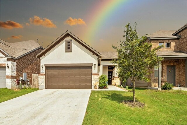 view of front of house featuring a garage and a lawn