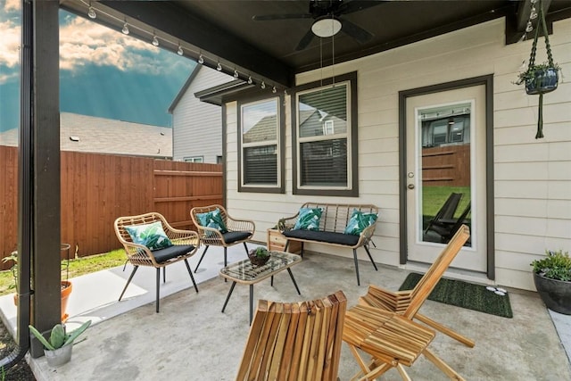 view of patio / terrace with ceiling fan and fence