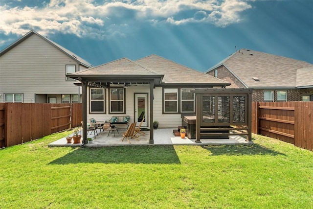 back of property with a fenced backyard, a deck, a patio, and a yard