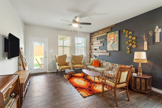 living room featuring ceiling fan and dark hardwood / wood-style floors