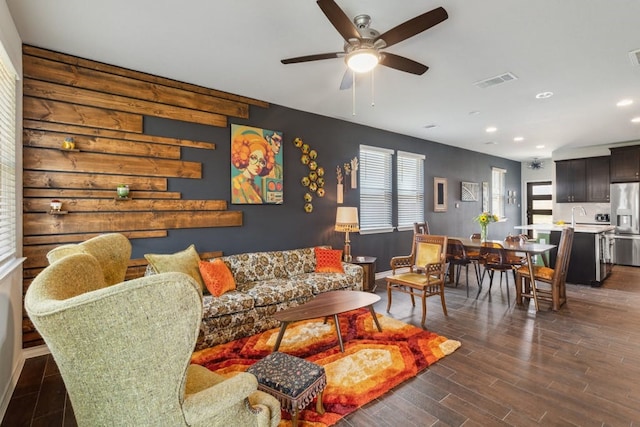 living room with sink, dark hardwood / wood-style floors, and ceiling fan