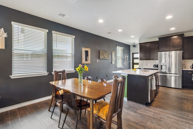 dining room featuring wood finish floors, visible vents, baseboards, and recessed lighting