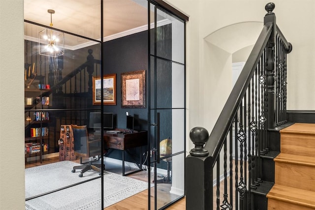 office area with wood-type flooring, crown molding, and an inviting chandelier