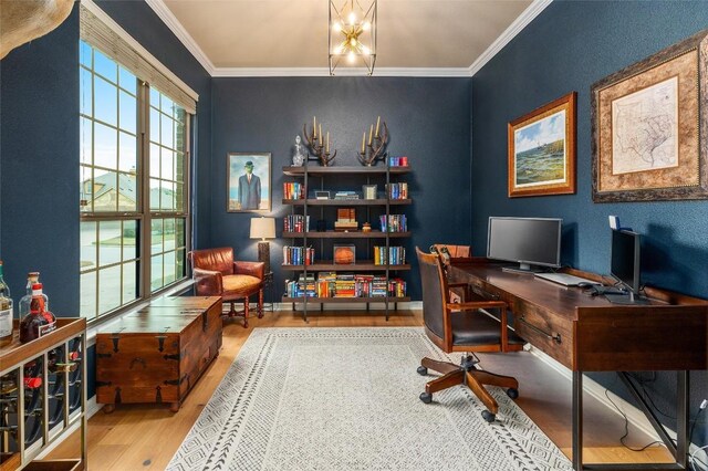 office space featuring crown molding, a notable chandelier, and hardwood / wood-style flooring