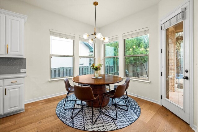 dining area featuring an inviting chandelier and light hardwood / wood-style flooring