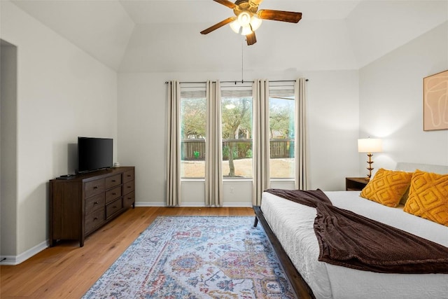 bedroom featuring lofted ceiling, ceiling fan, and light wood-type flooring