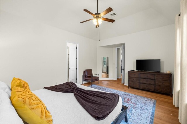 bedroom with light hardwood / wood-style flooring, ceiling fan, and vaulted ceiling