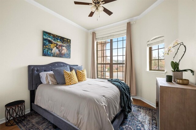 bedroom with crown molding, ceiling fan, and dark hardwood / wood-style floors