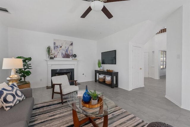 14420 Ballycastle Trl, Austin, TX 78717 - living area featuring a ceiling fan, a fireplace with raised hearth, baseboards, lofted ceiling, and wood finished floors