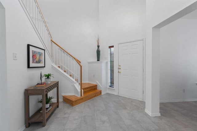 14420 Ballycastle Trl, Austin, TX 78717 - foyer entrance with stairway, a high ceiling, and baseboards