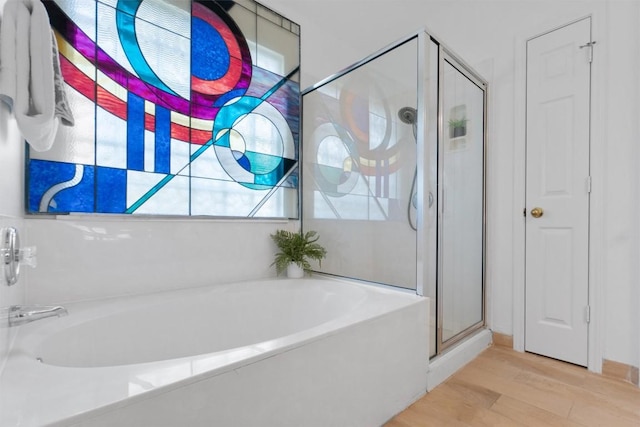 14420 Ballycastle Trl, Austin, TX 78717 - bathroom with a stall shower, a garden tub, and wood finished floors