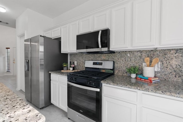 14420 Ballycastle Trl, Austin, TX 78717 - kitchen featuring appliances with stainless steel finishes, white cabinets, backsplash, light tile patterned floors, and light stone counters