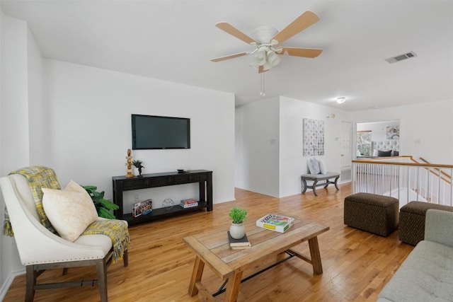 living room featuring ceiling fan and light hardwood / wood-style floors