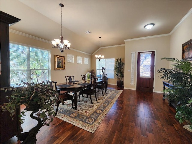 dining room featuring dark wood-type flooring, ornamental molding, a chandelier, and vaulted ceiling