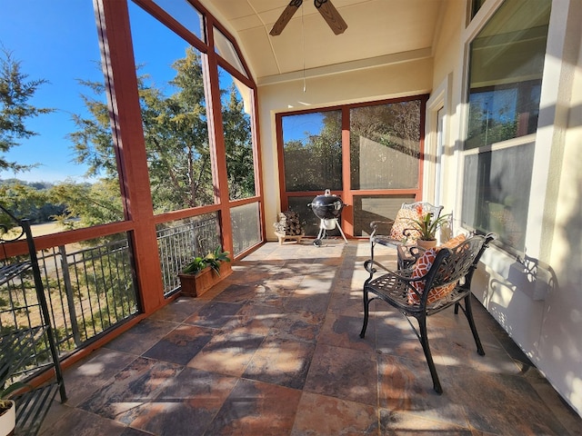 sunroom with lofted ceiling and ceiling fan