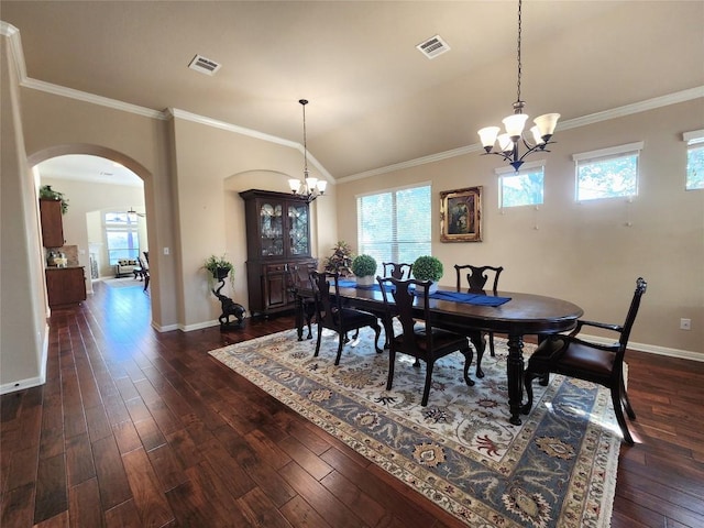 dining room featuring crown molding, dark hardwood / wood-style floors, and a chandelier