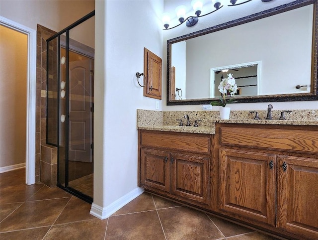 bathroom with an enclosed shower, vanity, and tile patterned flooring