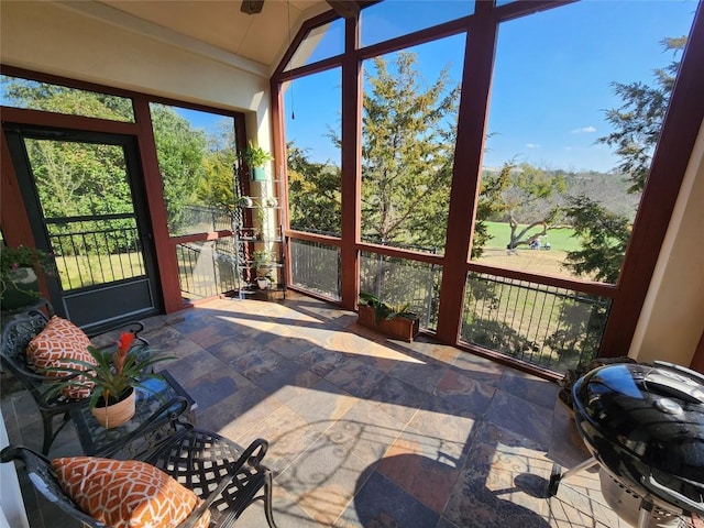 sunroom / solarium featuring vaulted ceiling